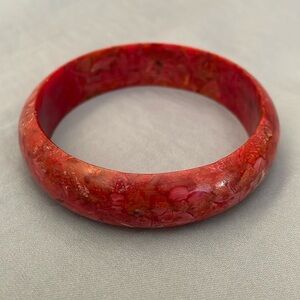 Stone-look orangey pink bangle, 2.75” diameter
